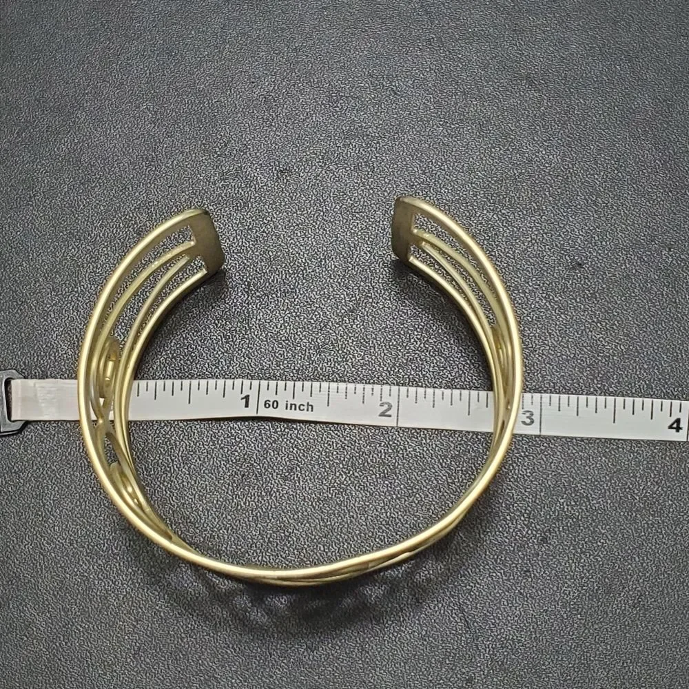 Gold tone swirly bangle cuff bracelet